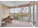Relaxing screened-in lanai with wicker furniture overlooking pond and landscaping at 7100 Islamorada Cir, Seminole, FL 33777