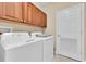 Laundry room with a washer, dryer, and wood cabinets at 7100 Islamorada Cir, Seminole, FL 33777