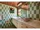 Bathroom featuring tiled walls and a vintage sink and cabinets at 724 69Th S Ave, St Petersburg, FL 33705