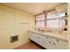 Retro style bathroom featuring tile flooring, wall cabinets and countertop at 724 69Th S Ave, St Petersburg, FL 33705