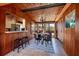 Dining room featuring wood paneled walls, tile floors, and seating for four at 724 69Th S Ave, St Petersburg, FL 33705