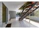 Open foyer with decorative concrete walls, terrazzo floor and geometric, floating wood staircase at 724 69Th S Ave, St Petersburg, FL 33705