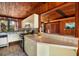 Bright kitchen featuring stainless steel appliances, tile counters, and wood ceilings at 724 69Th S Ave, St Petersburg, FL 33705
