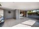 A bright living space with sliding glass doors to an outdoor living area and a terrazzo floor at 724 69Th S Ave, St Petersburg, FL 33705