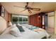 A main bedroom with closet, terrazzo floors, slider to screened porch, and ceiling fan at 724 69Th S Ave, St Petersburg, FL 33705