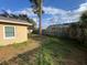 Exterior view of the backyard showing the yard and perimeter fencing at 7406 Coventry Dr, Port Richey, FL 34668