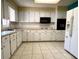 Kitchen boasts ample counter space, white cabinets, and modern appliances at 7406 Coventry Dr, Port Richey, FL 34668