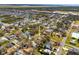 A high aerial view captures a residential area with many mature trees and the house is marked by an arrow at 7415 S Obrien St, Tampa, FL 33616