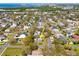 An aerial shot presents a quaint neighborhood, dotted with mature trees, and the house being sold is marked by an arrow at 7415 S Obrien St, Tampa, FL 33616