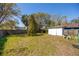 Spacious backyard with a shed and bordered by a wooden fence, offering privacy at 7415 S Obrien St, Tampa, FL 33616