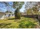 Private backyard oasis featuring a shed, bordered by a fence, and a small table set at 7415 S Obrien St, Tampa, FL 33616