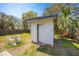 Backyard shed with a table and chairs set against the lush green backdrop at 7415 S Obrien St, Tampa, FL 33616