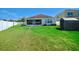 Spacious, well-maintained backyard featuring a shed, screened porch, and neat white fence for privacy and outdoor enjoyment at 8220 Round Leaf Ln, Riverview, FL 33578
