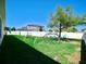 Lush backyard features play structures, ample lawn space, and a secure white fence, creating an ideal Gathering environment at 8220 Round Leaf Ln, Riverview, FL 33578