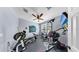 Home gym featuring full set of free weights, a flat screen tv and mirrored accent wall at 8220 Round Leaf Ln, Riverview, FL 33578