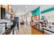 Kitchen view with wooden cabinets, black countertops, stainless steel appliances and a bold accent wall at 8220 Round Leaf Ln, Riverview, FL 33578