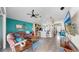 Spacious living room with modern furnishings, and an open layout with a view of the kitchen at 8220 Round Leaf Ln, Riverview, FL 33578