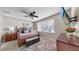 Tranquil main bedroom featuring a large window, ceiling fan, and dresser at 8220 Round Leaf Ln, Riverview, FL 33578