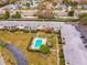 Aerial view of condo complex with a refreshing community pool and well-maintained landscaping at 8303 Bardmoor Blvd # 105, Seminole, FL 33777