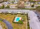 Aerial view of condo complex with a refreshing community pool and well-maintained landscaping at 8303 Bardmoor Blvd # 105, Seminole, FL 33777