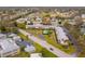 Aerial view of an apartment complex on a tree lined street with tennis courts in the background at 8303 Bardmoor Blvd # 105, Seminole, FL 33777