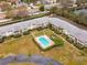 Aerial view of condo complex with a refreshing community pool and well-maintained landscaping at 8303 Bardmoor Blvd # 105, Seminole, FL 33777