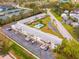 Aerial view of condo complex with parking, common areas, and convenient access to nearby tennis courts at 8303 Bardmoor Blvd # 105, Seminole, FL 33777