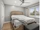 Bright bedroom with large window, ceiling fan, and comfortable bed at 8303 Bardmoor Blvd # 105, Seminole, FL 33777