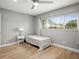 Cozy bedroom featuring a large window and hardwood floors, creating a warm and inviting space at 8303 Bardmoor Blvd # 105, Seminole, FL 33777