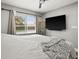 Neutral bedroom with a large window, a ceiling fan and a wall mounted tv at 8303 Bardmoor Blvd # 105, Seminole, FL 33777