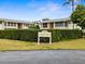 The Greenery complex sign with manicured bushes on a sunny day at 8303 Bardmoor Blvd # 105, Seminole, FL 33777