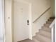 Condo entrance showcasing the front door, unit number, and stairway access to upper levels at 8303 Bardmoor Blvd # 105, Seminole, FL 33777