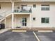 Condo exterior featuring a second floor balcony, designated parking, and landscaping at 8303 Bardmoor Blvd # 105, Seminole, FL 33777