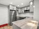 Updated kitchen with stainless steel appliances, sleek cabinets, and stylish countertop at 8303 Bardmoor Blvd # 105, Seminole, FL 33777