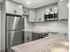 Contemporary kitchen boasts stainless steel appliances, a granite countertop, and modern cabinetry at 8303 Bardmoor Blvd # 105, Seminole, FL 33777