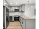 Modern kitchen featuring stainless steel appliances, gray cabinetry, and granite countertops at 8303 Bardmoor Blvd # 105, Seminole, FL 33777