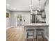 Kitchen with bar-style seating, stainless steel refrigerator, and bright lighting at 8303 Bardmoor Blvd # 105, Seminole, FL 33777