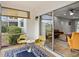 Cozy lanai with seating area opens to living room through sliding glass door at 8303 Bardmoor Blvd # 105, Seminole, FL 33777