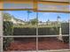 View from screened lanai of green landscaping, mulch bed and blue sky at 8303 Bardmoor Blvd # 105, Seminole, FL 33777