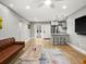 Open-concept living room features wood floors and seamless flow into kitchen at 8303 Bardmoor Blvd # 105, Seminole, FL 33777