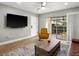 Modern living room boasts hardwood floors, ceiling fan, and access to a screened-in patio at 8303 Bardmoor Blvd # 105, Seminole, FL 33777