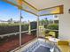 Screened patio with neutral colors and views of the well-manicured lawn and landscaping at 8303 Bardmoor Blvd # 105, Seminole, FL 33777