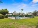 Community pool surrounded by a fence, offering a place to unwind and enjoy sunny days at 8303 Bardmoor Blvd # 105, Seminole, FL 33777