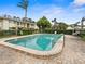 A clean community pool on a bright day surrounded by brick and green landscaping at 8303 Bardmoor Blvd # 105, Seminole, FL 33777