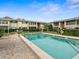 A shared pool is surrounded by well-kept landscaping and low-rise brick buildings at 8303 Bardmoor Blvd # 105, Seminole, FL 33777