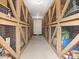 Storage units with wooden lattice doors in a well-lit hallway at 8303 Bardmoor Blvd # 105, Seminole, FL 33777