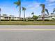 Street view of a low-rise apartment complex surrounded by palm trees and landscaping at 8303 Bardmoor Blvd # 105, Seminole, FL 33777