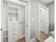 Spacious white walk-in closet with custom shelving and drawers for maximum organization and style at 8303 Bardmoor Blvd # 105, Seminole, FL 33777