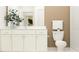 Well-lit bathroom with white cabinetry and neutral tones at 9693 Runaway Breeze Dr, Land O Lakes, FL 34637