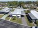 This property features an aerial view of a well-maintained mobile home, carport, small yard and mature landscaping at 9790 66Th N St # 469, Pinellas Park, FL 33782